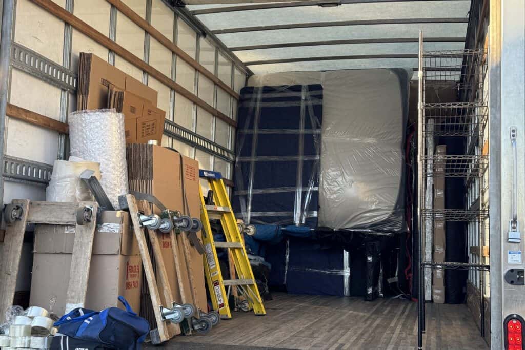 Fully loaded Expedite Moving truck with blanket-wrapped furniture
