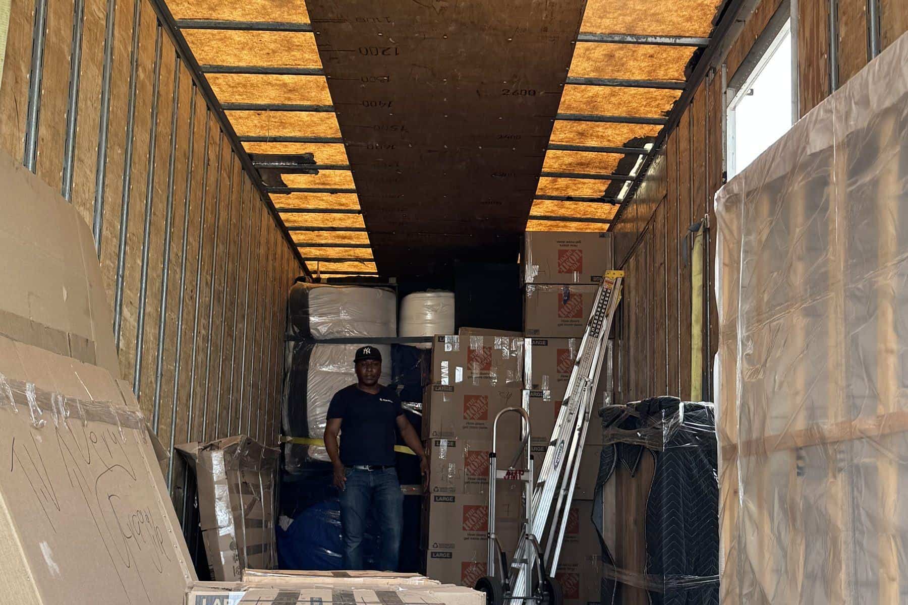 Expedite Moving truck packed with blanket-wrapped furniture and labeled boxes
