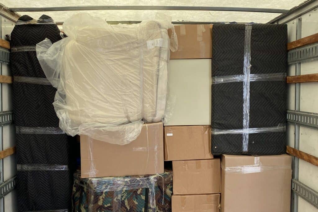 Blanket-wrapped furniture and boxes packed for storage by Expedite Moving